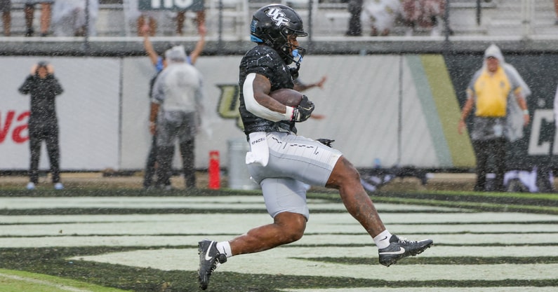 Nov 2, 2024; Orlando, Florida, USA; UCF Knights running back RJ Harvey (7) scores a touchdown against the Arizona Wildcats during the first quarter at FBC Mortgage Stadium. Mandatory Credit: Mike Watters-Imagn Images