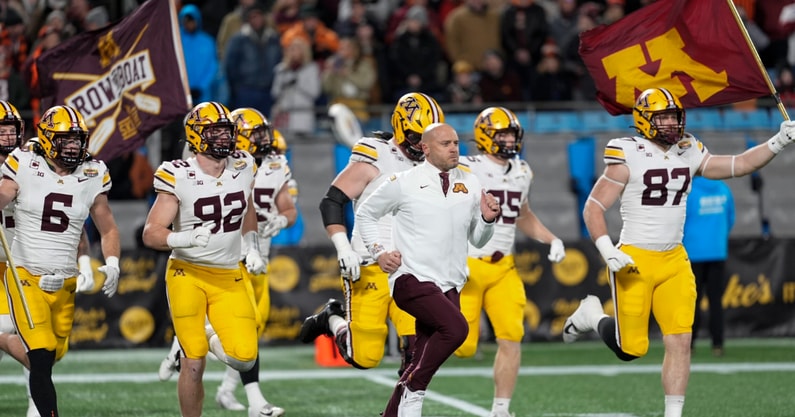 Jan 3, 2025; Charlotte, NC, USA; Minnesota Golden Gophers head coach P.J. Fleck leads his team onto the field during the first quarter against the Virginia Tech Hokies at the DukesÕ Mayo Bowl at Bank of America Stadium. Mandatory Credit: Jim Dedmon-Imagn Images