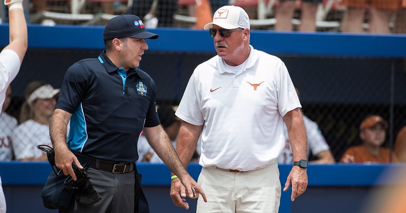 Texas softball coach Mike White with an umpire at the WCWS