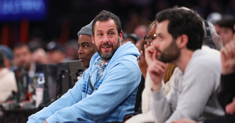 Jan 20, 2025; New York, New York, USA; Actor and comedian Adam Sandler looks on during the first half of the NBA game between the New York Knicks and the Atlanta Hawks at Madison Square Garden. Mandatory Credit: Vincent Carchietta-Imagn Images
