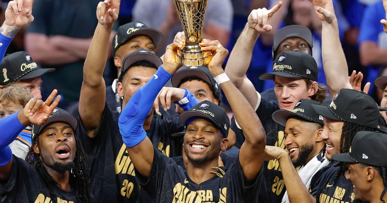 Jun 22, 2025; Oklahoma City, Oklahoma, USA; Oklahoma City Thunder guard Shai Gilgeous-Alexander (2) holds up his NBA Finals Bill Russell MVP trophy at the end of game seven of the 2025 NBA Finals after defeating the Indiana Pacers at Paycom Center. Mandatory Credit: Alonzo Adams-Imagn Images