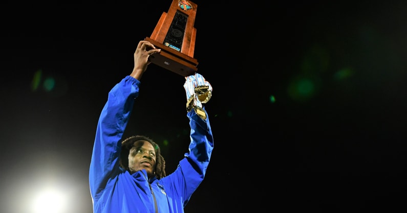 Miami Northwestern coach Teddy Bridgewater holding the state championship trophy.