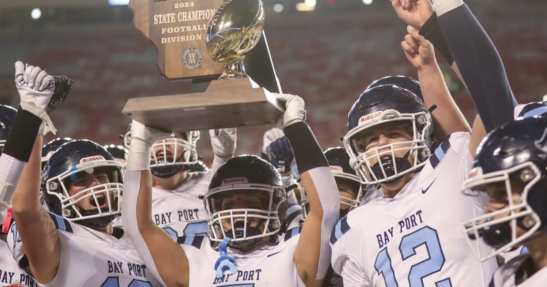 The Bay Port football team celebrates its Wisconsin high school football state championship win over Muskego.