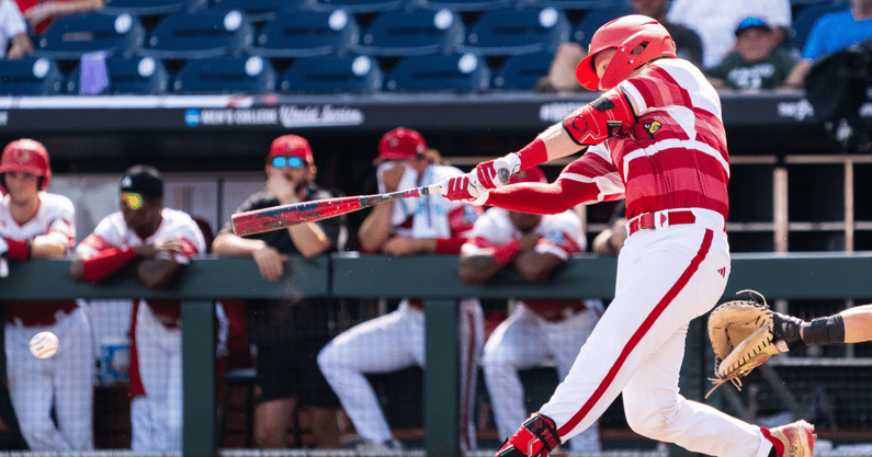 Jun 18, 2025; Omaha, Neb, USA; Louisville Cardinals catcher Tagger Tyson (36) hits a single against the Coastal Carolina Chanticleers during the ninth inning at Charles Schwab Field. Mandatory Credit: Dylan Widger-Imagn Images