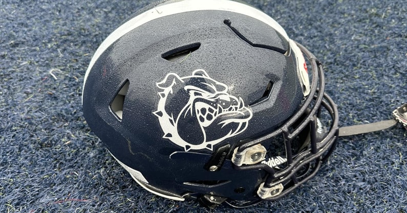 The helmet of a Portland Bulldogs player sits on the field before a Maine high school football game.
