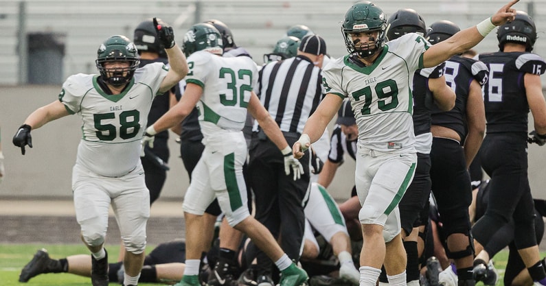 The Eagle Mustangs celebrate a defensive stop in an Idaho high school football game.