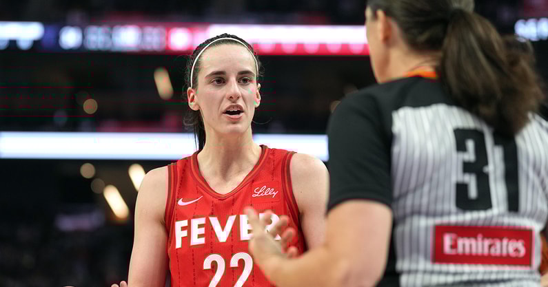 Indiana Fever guard Caitlin Clark talks with a refere