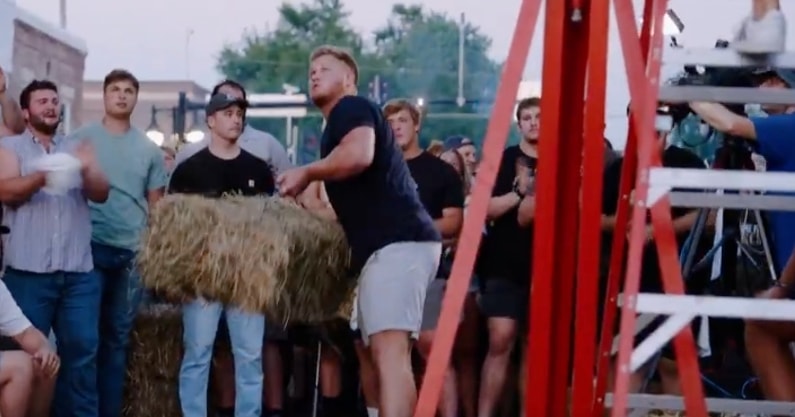 Iowa OL Kade Pieper defends Solon Beef Days hay bale toss title with 13-foot throw