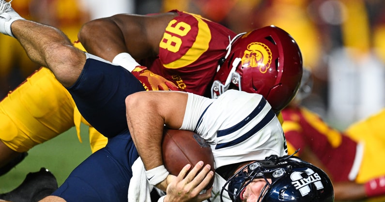 USC Trojans defensive end Devan Thompkins (98) sacks Utah State Aggies quarterback Bryson Barnes (16) during the third quarter at United Airlines Field at Los Angeles Memorial Coliseum