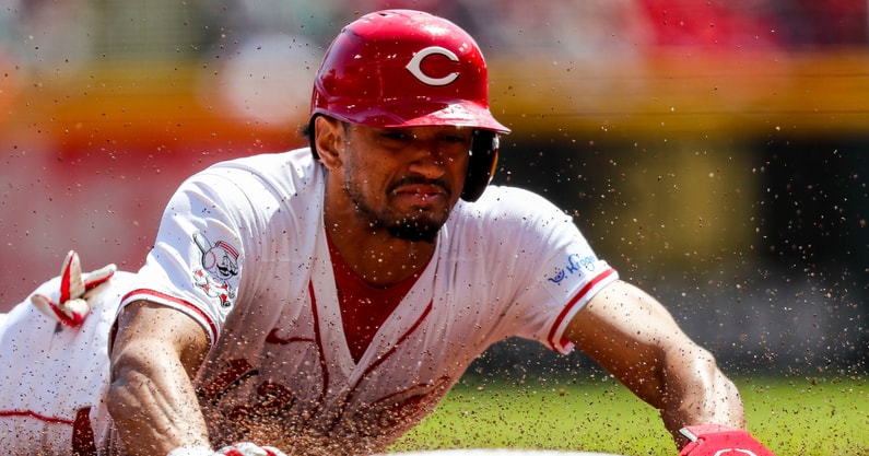 Apr 7, 2024; Cincinnati, Ohio, USA; Cincinnati Reds center fielder Bubba Thompson (12) steals third base in the third inning against the New York Mets at Great American Ball Park. Mandatory Credit: Katie Stratman-Imagn Images