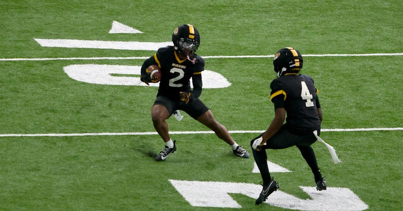 Marquis Johnson jukes past James Madison during a drill