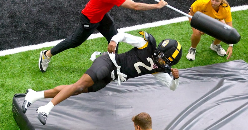 Marquis Johnson dives onto a pad during a drill