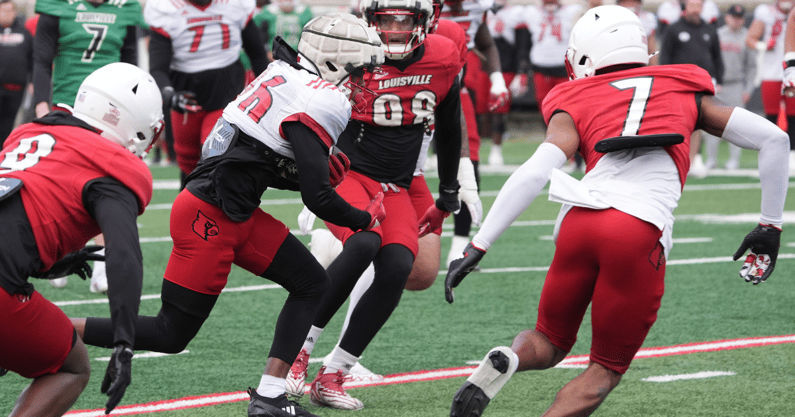 Louisville Duke Watson (26) catches the ball and ran from some yardage against Red Louisville Rodney Johnson (7) in the Spring Game Friday night at L & N Stadium. April 11, 2025