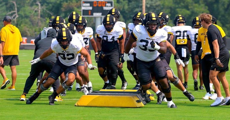 Marquis Gracial (33) and Daeden Hopkins (93) lead a line in warmups