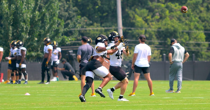 Josiah Trotter (left) and Jackson Daily (right) fight for a ball during a drill