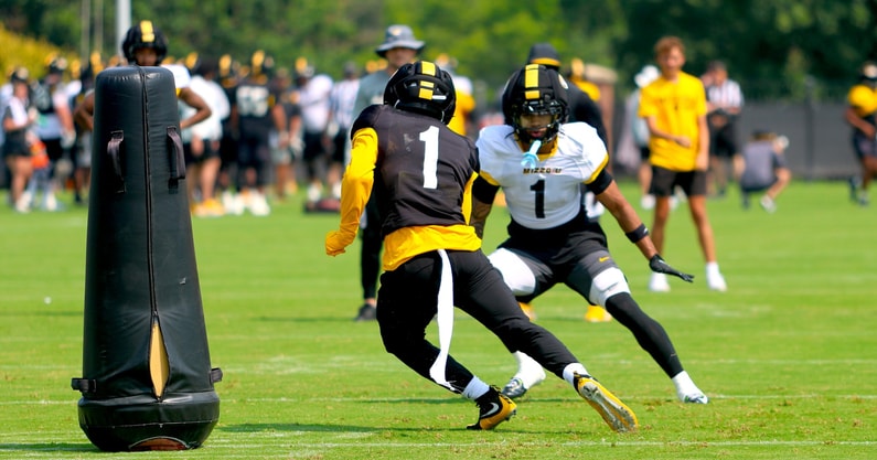Donovan Olugbode (black jersey) tries to get around Marvin Burks (white jersey)