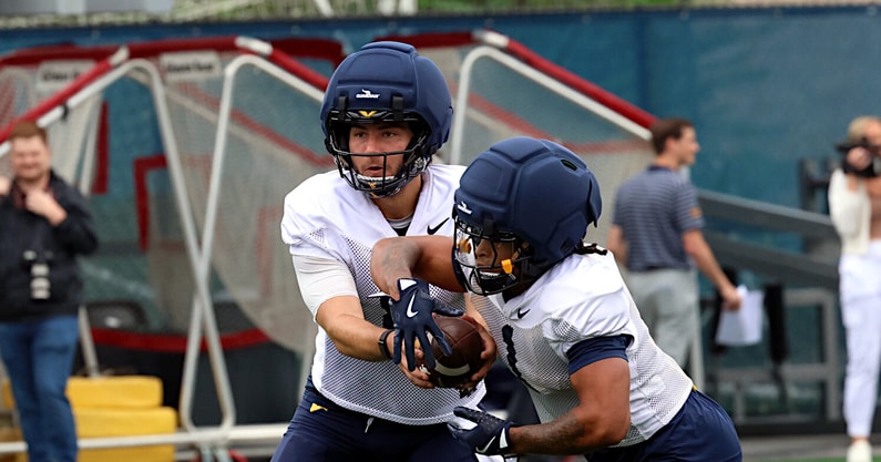 West Virginia quarterback Nicco Marchiol handsoffs to running back Jahiem White during fall practice