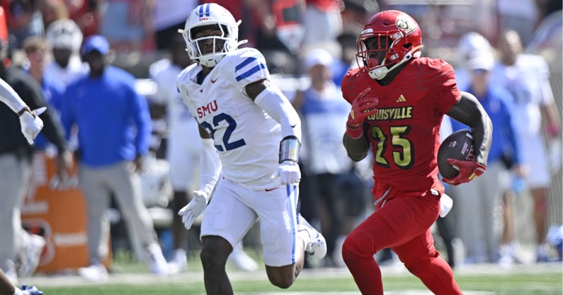 Oct 5, 2024; Louisville, Kentucky, USA; Louisville Cardinals running back Isaac Brown (25) runs the ball against Southern Methodist Mustangs safety Cale Sanders Jr. (22) during the second half at L&N Federal Credit Union Stadium. Mandatory Credit: Jamie Rhodes-Imagn Images