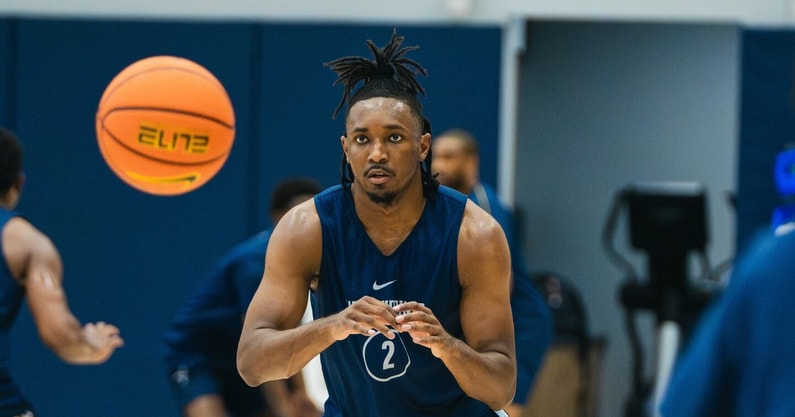 West Virginia guard Chance Moore bringing in the pass at practice