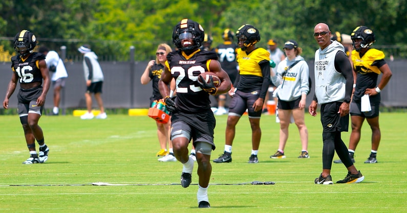 Ahmad Hardy runs through a read drill with RB coach Curtis Luper (back right) talking to him