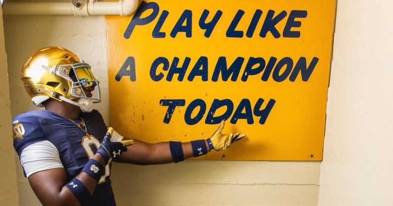 Elijah Golden with Notre Dame's Play Like A Champion Today sign.