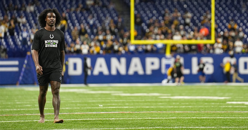 Tony Brown walks with staff ahead of game