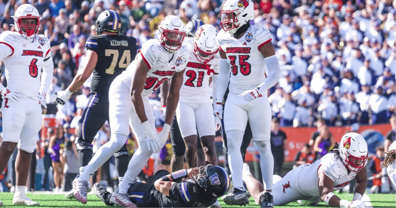Louisville football's A.J. Green (98) and Antonio Watts (35) celebrate a tackle for loss in the 35-34 2025 Sun Bowl win over Washington.