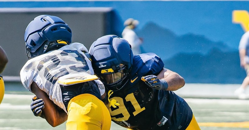 West Virginia's football players go through a preaseason scrimmage
