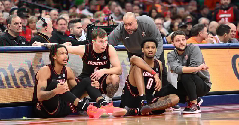 Jan 14, 2025; Syracuse, New York, USA; Louisville Cardinals assistant coaches Brian Kloman (standing) and Mike Cassidy give instructions to forward Khani Rooths (9) and guard Reyne Smith (6) and forward James Scott (0) before entering the game in the second half against the Syracuse Orange at the JMA Wireless Dome. Mandatory Credit: Mark Konezny-Imagn Images
