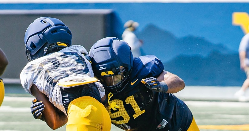 West Virginia's defender closes in on the ball carrier during practice
