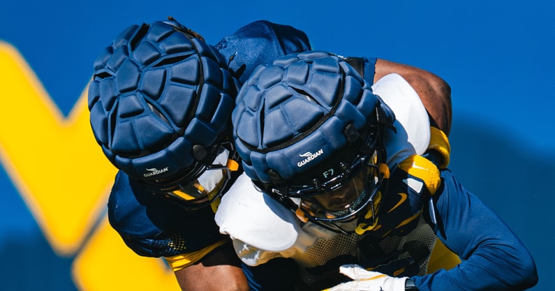 The West Virginia defender makes the tackle during practice