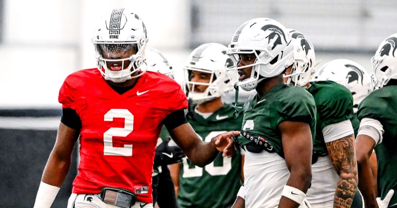 Michigan State quarterback Aidan Chiles, left, talks with Nick Marsh during a break in football practice on Tuesday, April 8, 2025, in East Lansing. - Nick King, USA TODAY Sports