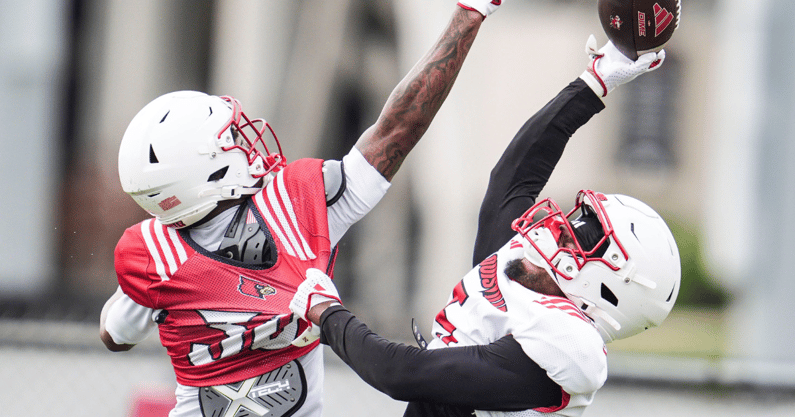 Louisville Cardinals wide receiver Caullin Lacy (5) tries to make a catch under pressure from defensive back Rae'mon Mosby (30) during a recent practice on August 4, 2025 before the start of the 2025 football season.