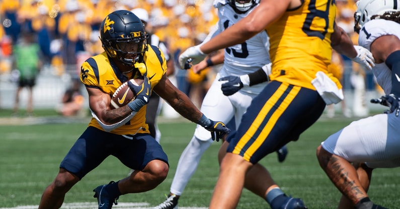 West Virginia running back Jahiem White carries the ball during a game