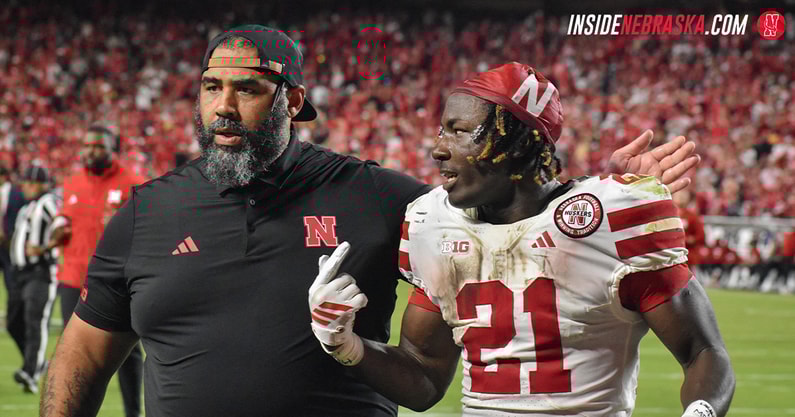 Nebraska football OLB coach Phil Simpson and running back Emmett Johnson walking off the field at halftime of the Huskers' 20-17 win over Cincinnati