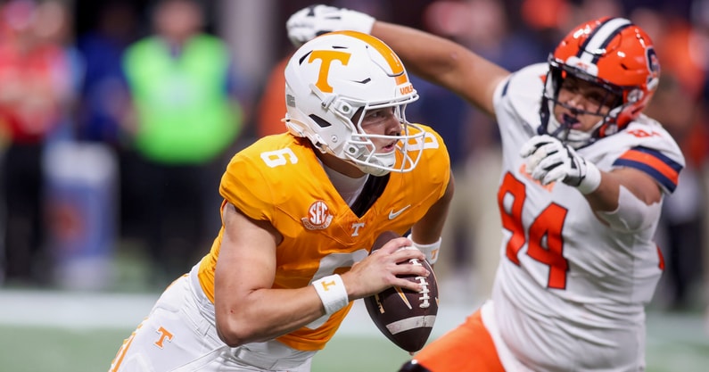 Aug 30, 2025; Atlanta, Georgia, USA; Tennessee Volunteers quarterback Joey Aguilar (6) scrambles past Syracuse Orange defensive lineman Kevin Jobity Jr. (94) in the first quarter at Mercedes-Benz Stadium. Mandatory Credit: Brett Davis-Imagn Images