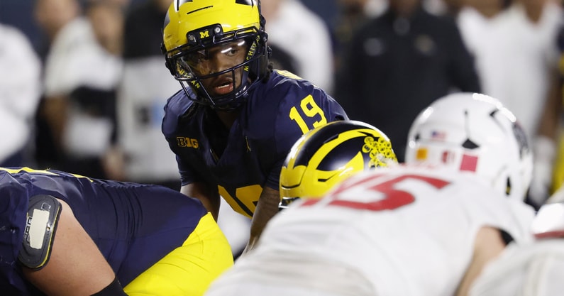 Aug 30, 2025; Ann Arbor, Michigan, USA;  Michigan Wolverines quarterback Bryce Underwood (19) gets set to run a play in the first half against the New Mexico Lobos at Michigan Stadium. Mandatory Credit: Rick Osentoski-Imagn Images