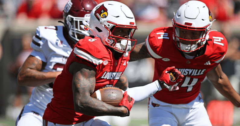 Aug 30, 2025; Louisville, Kentucky, USA; Louisville Cardinals wide receiver Caullin Lacy (5) runs the ball against Eastern Kentucky Colonels linebacker Blake Howard (37) during the first quarter at L&N Federal Credit Union Stadium. Mandatory Credit: Jamie Rhodes-Imagn Images