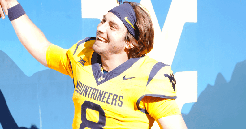 West Virginia quarterback Nicco Marchiol with fans after the Robert Morris win