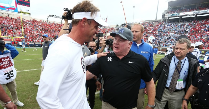 Sep 28, 2024; Oxford, Mississippi, USA; Mississippi Rebels head coach Lane Kiffin (left) and Kentucky Wildcats head coach Mark Stoops (right) embrace after the game at Vaught-Hemingway Stadium. Mandatory Credit: Petre Thomas-Imagn Images