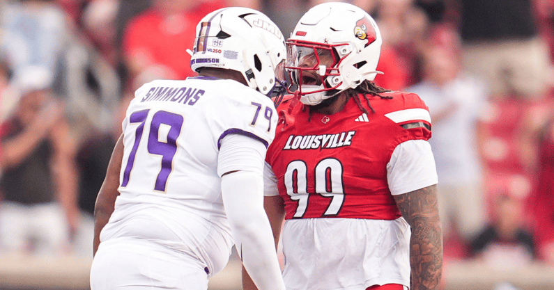 Louisville Cardinals defensive lineman Jordan Guerad (99) has words with James Madison Dukes offensive lineman Joseph Simmons (79) in the first half during the Louisville-James Madison college football game Friday September 5, 2025 at L&N Credit Union Stadium in Louisville, Kentucky.