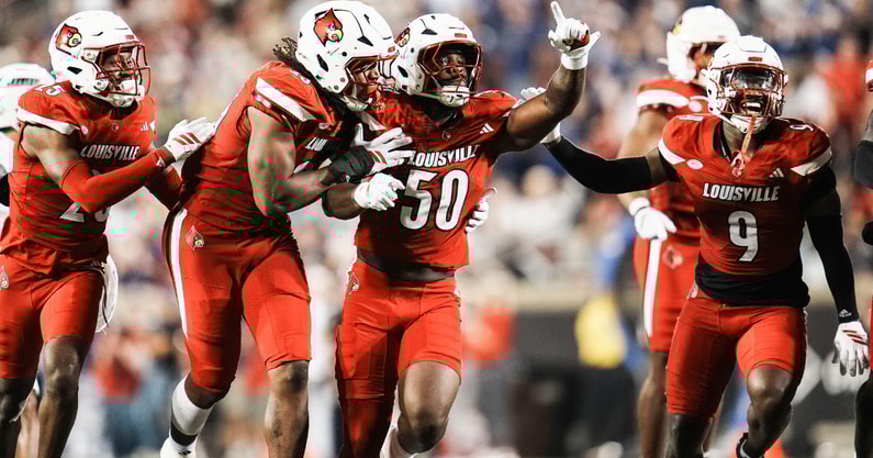 Louisville Cardinals defensive lineman Clev Lubin (50) and teammates Louisville Cardinals defensive back Tayon Holloway (25), left, and Louisville Cardinals defensive lineman Wesley Bailey (23) and Louisville Cardinals linebacker Antonio Watts (9) celebrate creating a turnover on James Madison University as the Cards' beat the visiting Dukes 28-14 Friday September 5, 2025 at L&N Credit Union Stadium in Louisville, Kentucky.