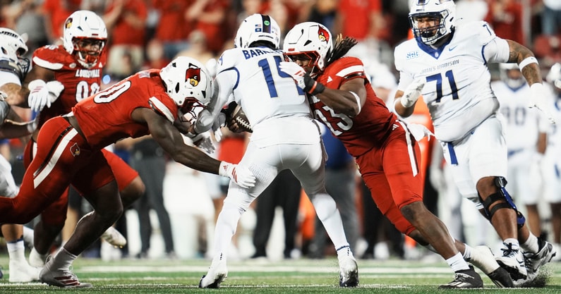 Louisville Cardinals defensive lineman Clev Lubin (50) and Louisville Cardinals defensive lineman Wesley Bailey (23) sack DUPLICATE***James Madison Dukes quarterback Alonza Barnett III (14) in the first half during the Louisville-James Madison college football game Friday September 5, 2025 at L&N Credit Union Stadium in Louisville, Kentucky.