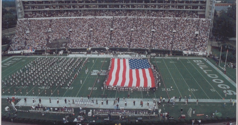 South Carolina and Mississippi State players joined together with military personnel to unfurl the American flag in the first major sporting event after 9/11. Photo credit: Mississippi State Athletics | @msstate on Twitter/X