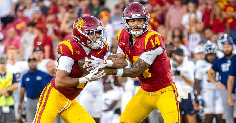 USC quarterback Jayden Maiava hands off to running back Eli Sanders
