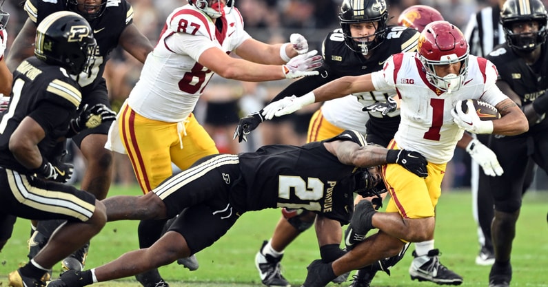 USC Trojans running back Eli Sanders (1) is tackled by Purdue Boilermakers defensive back Tahj Ra-El (21) during the second quarter at Ross-Ade Stadium