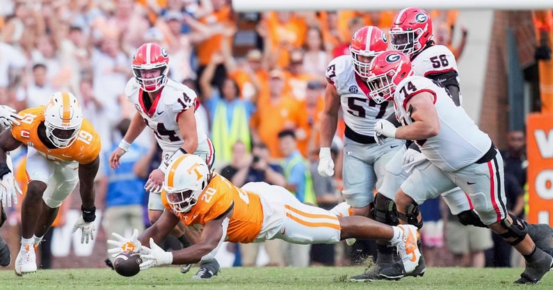 Angelina Alcantar/News Sentinel / USA TODAY NETWORK via Imagn Images | Tennessee defensive lineman Bryson Eason (20) jumps onto the ball after Georgia quarterback Gunner Stockton (14) drops the ball during a NCAA football game between Tennessee and Georgia at Neyland Stadium in Knoxville, Tennessee, on September 13, 2025.