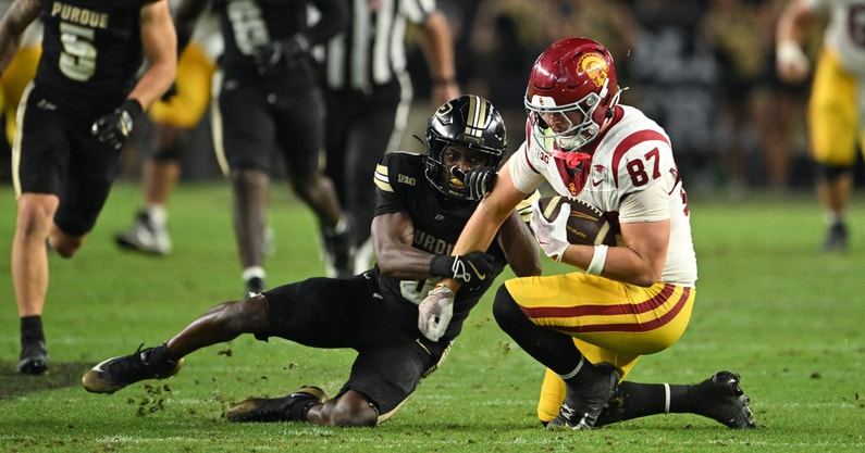 Purdue Boilermakers defensive back Tony Grimes (0) tackles USC Trojans tight end Lake McRee (87) during the second half at Ross-Ade Stadium