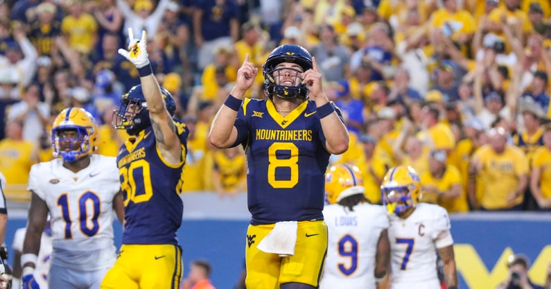 West Virginia quarterback Nicco Marchiol celebrates the touchdown against Pitt