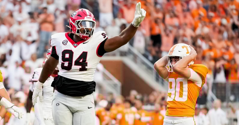 Brianna Paciorka/News Sentinel / USA TODAY NETWORK via Imagn Images | Tennessee place kicker Max Gilbert (90) holds his helmet in disbelief as Georgia defensive lineman Xzavier McLeod (94) celebrates Gilbert's missed field goal in the final seconds of a college football game between Tennessee and Georgia at Neyland Stadium in Knoxville, Tenn., on Sept. 13, 2025.